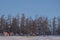 Small house near forest on frozen Lake Khovsgol with blue sky background