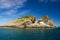 Small house on the rocks in the sea