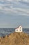 Small house on sea background. Purchase of real estate by sea. Construction of cottage on shore