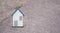 Small house standing on a road, real estate concept, renting or buying a home, travel and vacation symbol