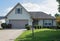 Small House with Tan Shutters and Trim