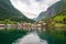 Small houses of the commune on the fjord, photographed from a sightseeing cruise ferry departing in summer from Flam, Norway