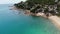 Small houses on tropical island. Tiny cozy bungalows located on shore of Koh Samui Island near calm sea on sunny day in Thailand.