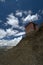 A small hut built in brick and clay atop a hill in the scenic landscapes of Ladakh state, India.