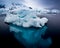 Small ice berg in clear, calm water showing turquoise ice underwater