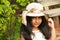 Small Indian girl wearing round fancy cap looking at camera, Pune