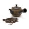 Small individual ceramic teapot and scattered tea