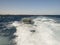 Small inflatable boat in ships wake