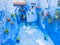 Small inner yard in Chefchaouen, Morocco with colorful flowerpots on blue walls