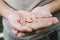 Small intra channel hearing aid device in a man`s hands.