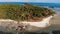 Small island and coral reef in ocean. Drone view of green uninhabited island and amazing coral reef in calm sea on sunny day in