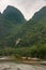 Small island in front of karst mountains along Li River in Guilin, China