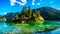 Small island in the middle of the crystal clear waters of Pavilion Lake in Marble Canyon Provincial Park, British Columbia