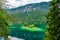 Small islands with pine-trees in the middle of Eibsee lake with Zugspitze mountain. Beautiful landscape scenery with paradise