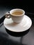 Small Ivory White Demitasse Espresso Cup with Matching Saucer on a Black Serving Tray, Coffee Foam Inside of the Cup