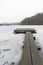 Small jetty on a frozen lake with forest