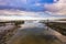 Small jetty with harbor along the coastline of the wadden island of Texel