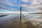 Small jetty with harbor along the coastline of the wadden island of Texel