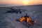 Small kettle stands on a burning bonfire