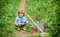 Small kid gardener planting a flower. earth day. Eco life. summer activity. happy child farmer use garden shovel, spring