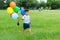 Small kid hold with group of balloon