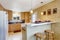 Small kitchen area with granite tops, white appliances