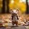 a small knitted mouse in a sweater standing in the fall leaves