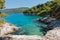 Small lagoon with pine trees and rocks over crystal clear turquoise water near Cape Amarandos at Skopelos island