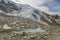 Small lake on Hohsaas with beautifull views on Trift glacier in Swiss Alps