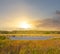 Small lake among a prairies at the sunset