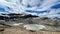 Small lake surrounded by rocky hills in the Great Divide Trail, Canada