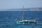 Small launch boat with people, blue sea and sky