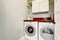 Small laundry room with tile floor, door, and wash dryer.