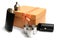 Small leather hip flask with three metal mugs and funnel at orange giftbox