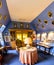 A small library with family portraits on walls in a loft room, Crathes Castle, Scotland