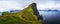 Small lighthouse located near huge cliffs on island of Kalsoy, Faroe Islands