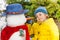 Small little boy put carrot making snowman