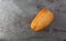 Small loaf of wheat bread offset on a gray mottled background top view