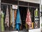 Small local clothes store and tailor service displaying traditional colorful textile in the shop windows.