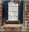 Small locked gate in a brick wall