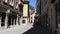 A small lonely street in the historic center of Regensburg Germany in the summer. People are walking along a narrow