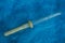 Small long medical pipette on blue wool