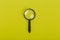 Small magnifying glass on green background