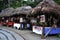 Small market with Indigenous shops with roofs made of leaves selling local handicrafts in ecuador, latin america