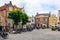 A small market square with terraces and many cycling tourists.