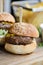 Small meat burger sliders on wooden table