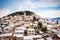 Small Mediterranean town on slopes of hill with church on top