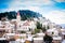 Small Mediterranean town on slopes of hill with church on top