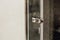 Small metal handle for a glass door in a shower cabin view in the interior