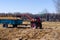 Small mini red tractor stands on a farm yard. Springtime and harvest concept.